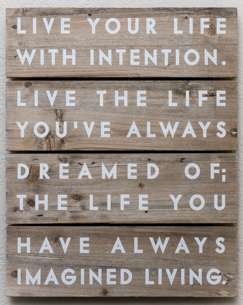 A wooden sign with the words live your life