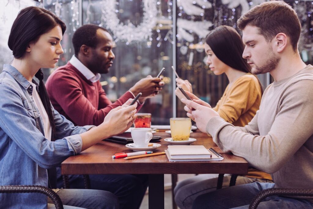 A group of people sitting at a table with food.