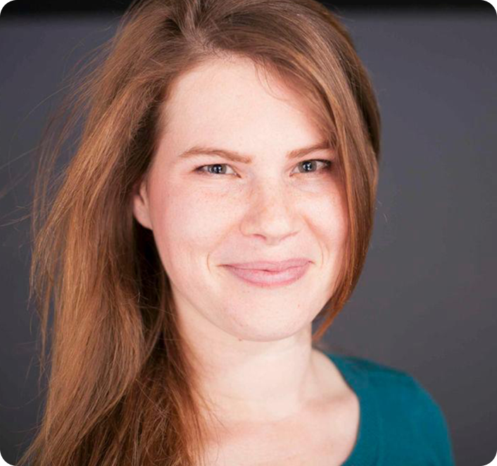 A woman with long hair is smiling for the camera.