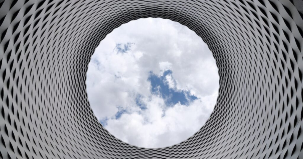 A circular window with a sky view in the center.