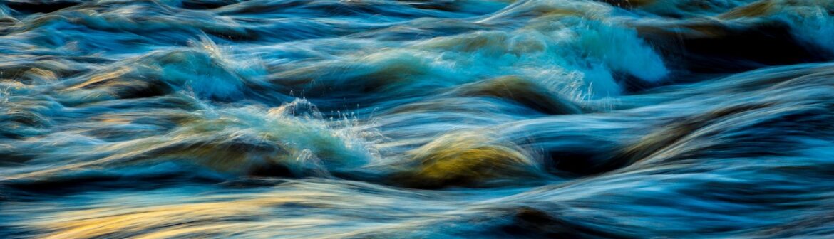 A very close up view of some water waves.