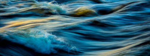 A very close up view of some water waves.
